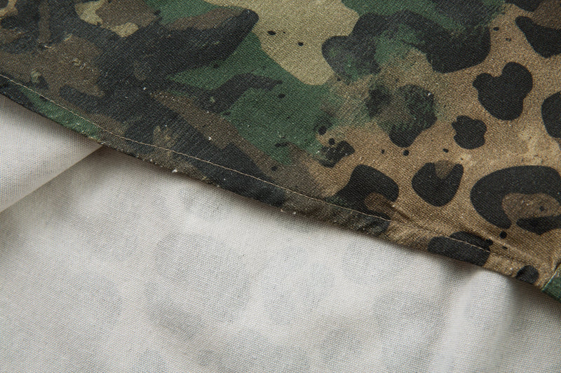 Close-up of hem stitching on camo leopard utility shirt