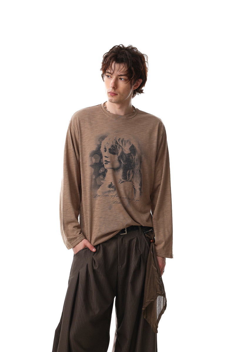 Model wearing brown long sleeve tee with faded portrait graphic, front view