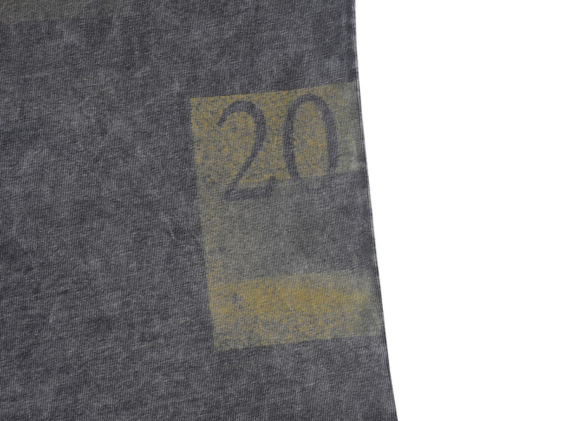 Close-up of a charcoal vintage wash oversized tee with faded yellow graphic print on soft cotton fabric