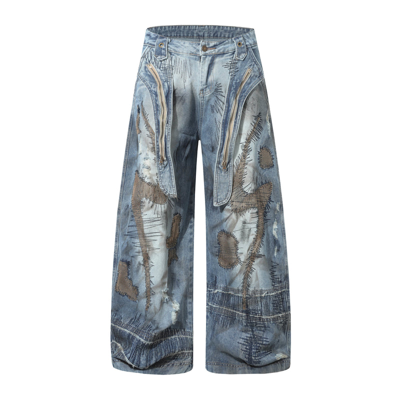 Wide-leg distressed patchwork blue jeans with zip details, front view