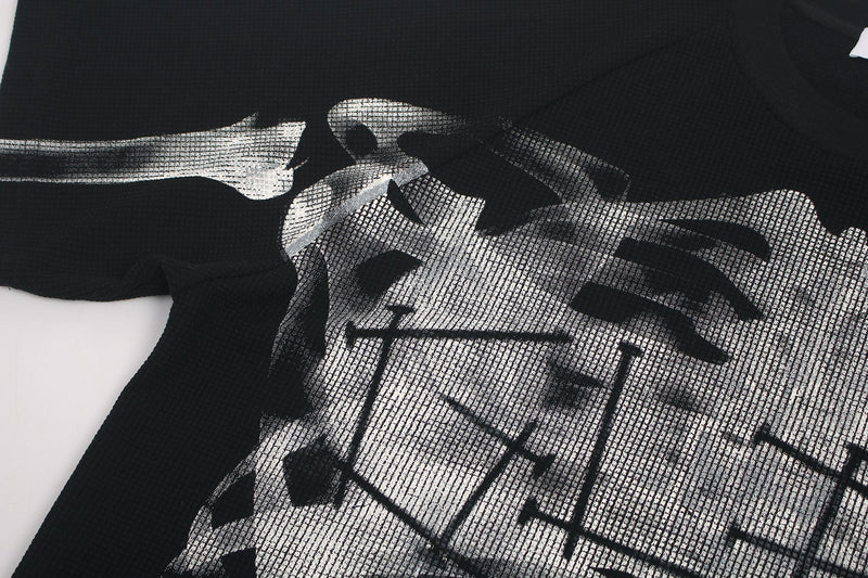 Black oversized graphic tee with a pixelated X-ray skeleton print across the chest and sleeves