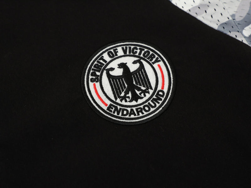 Black streetwear button-up shirt with Spirit of Victory eagle patch and camo panel detail