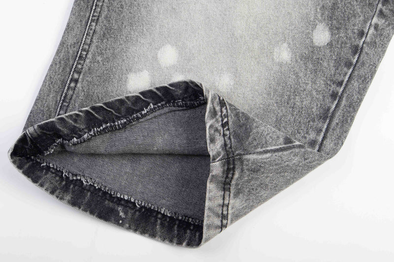Close-up of the hem showing a cuffed wide-leg denim opening and inner seam