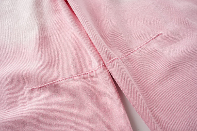 Close-up of pink washed denim seam detail between the legs