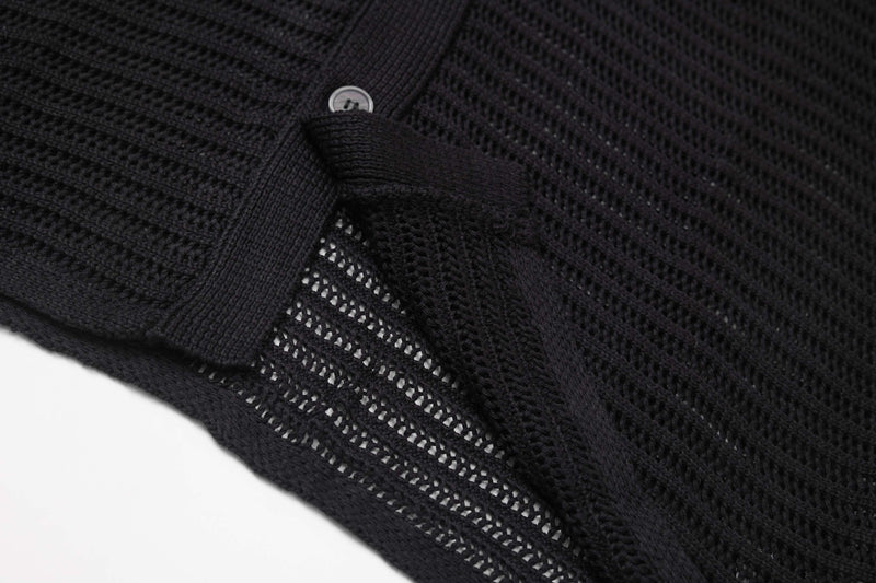 Black open-knit short-sleeve button-up shirt with star texture and ribbed trim, shown in a close-up detail view