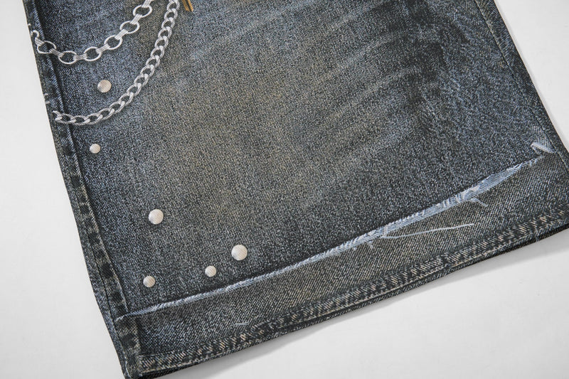 Lower leg close-up with chain print, distressed denim hem, and faded wash