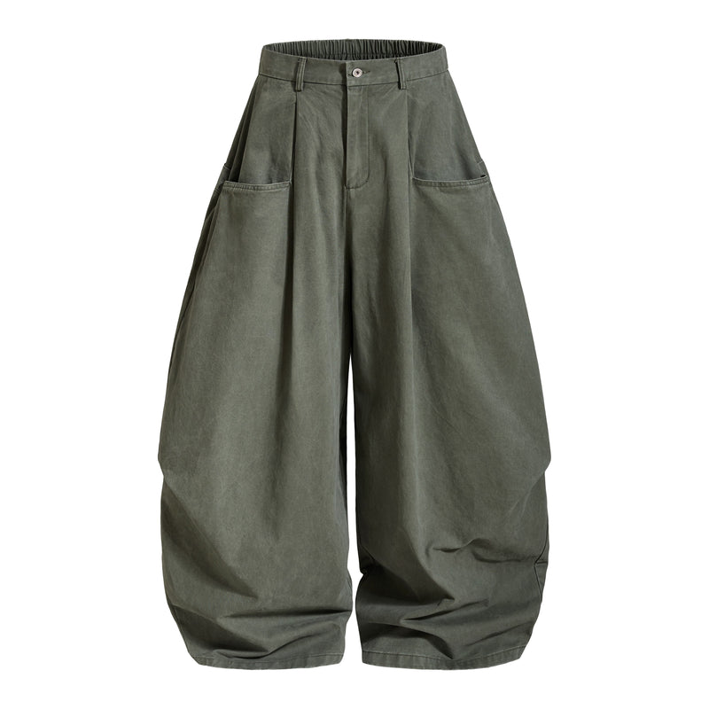 Olive green wide-leg pants front view with pleats and oversized silhouette