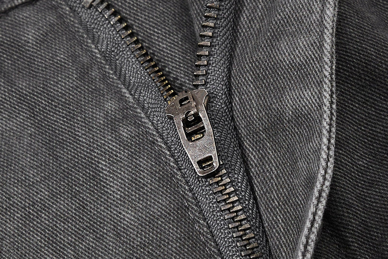 Close-up of dark gray zipper fly on utility cargo pants