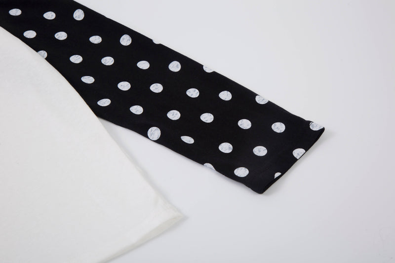 Folded black sleeve with white polka dots and white sleeve with black polka dots