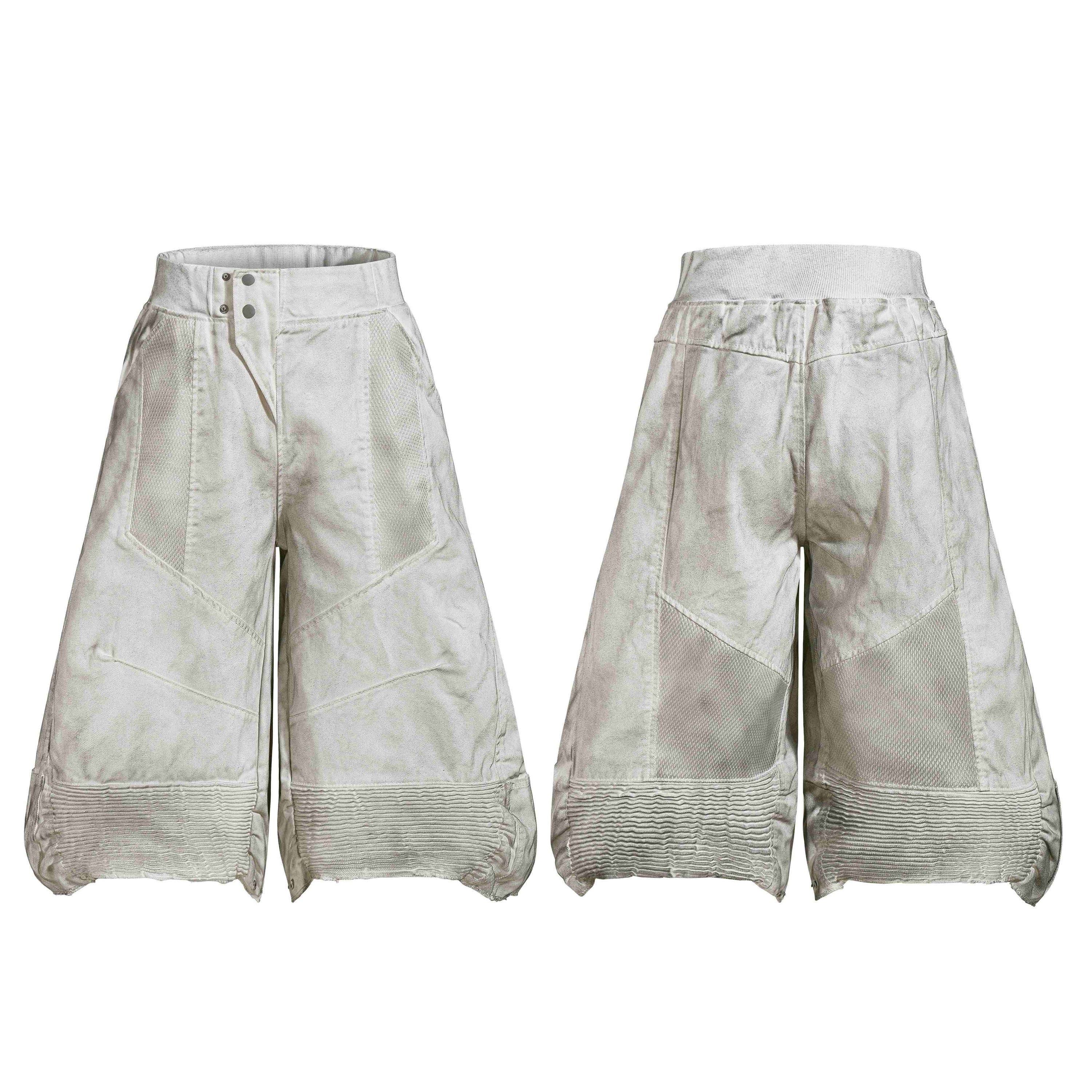 Front and back view of oversized wide-leg moto panel denim shorts in vintage washed off-white with mesh inserts and ribbed he