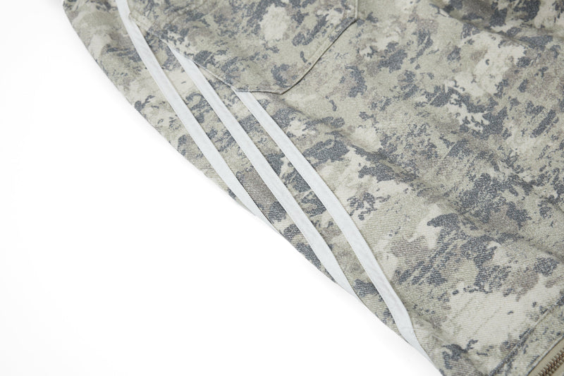 Close-up of reflective side stripes running down the camouflage pant leg