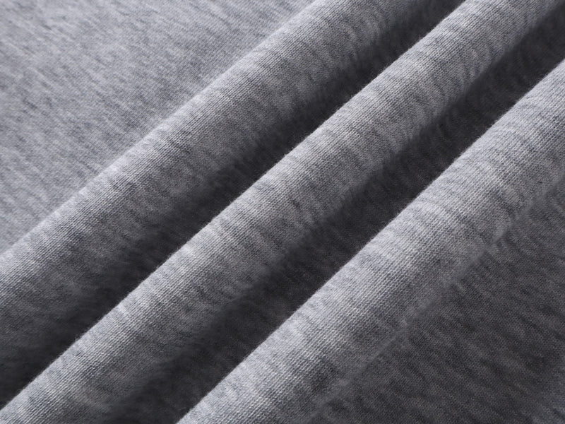 Close-up of gray hoodie fabric texture with folded sleeve surface