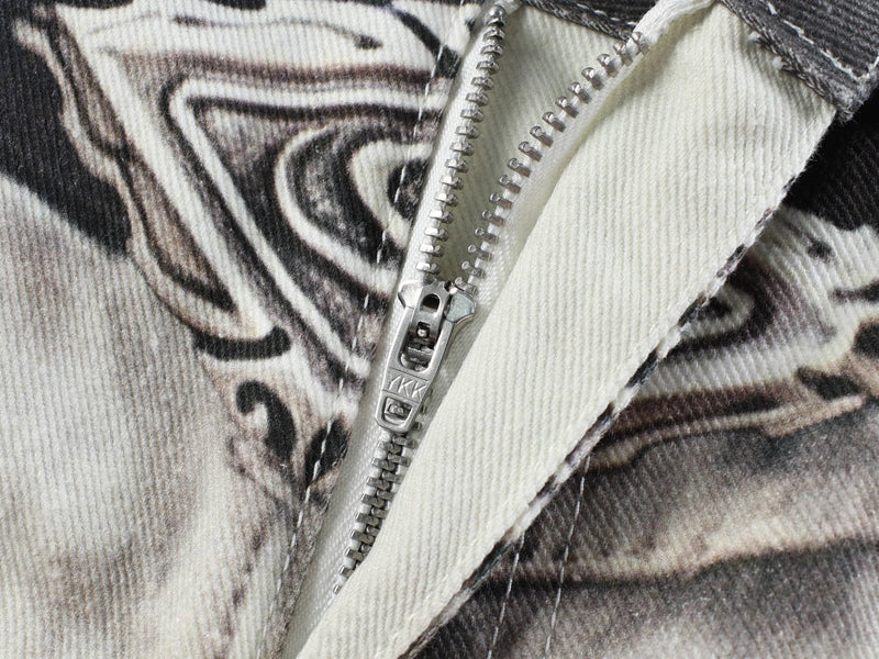 Close-up of zipper fly with black-and-white abstract printed denim