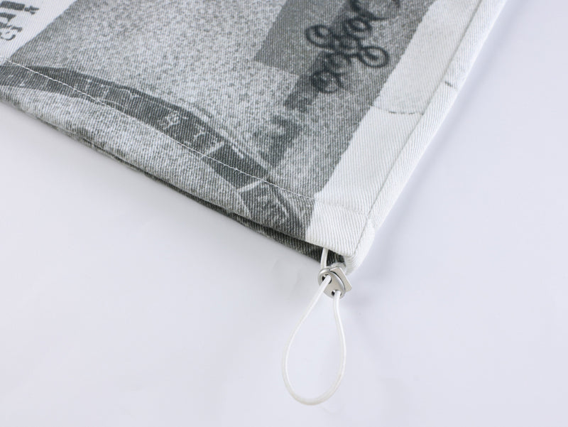 Close-up of pants hem with white drawstring loop and seam detail