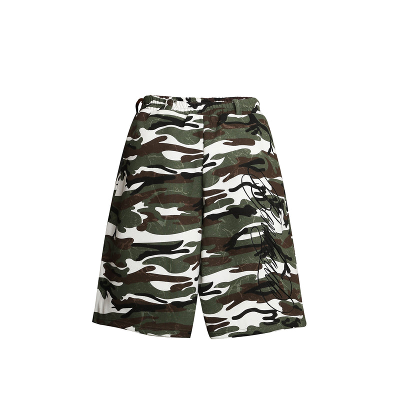 Front view of loose camouflage shorts with white graphic print on one leg