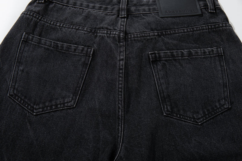 Close-up of both back pockets and waistband on black denim jeans