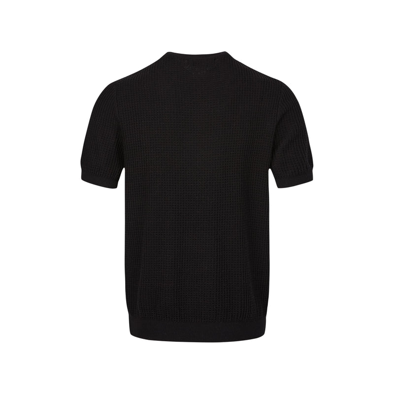 Black waffle knit short-sleeve sweater with relaxed fit, textured cotton blend, and ribbed hem on a white background