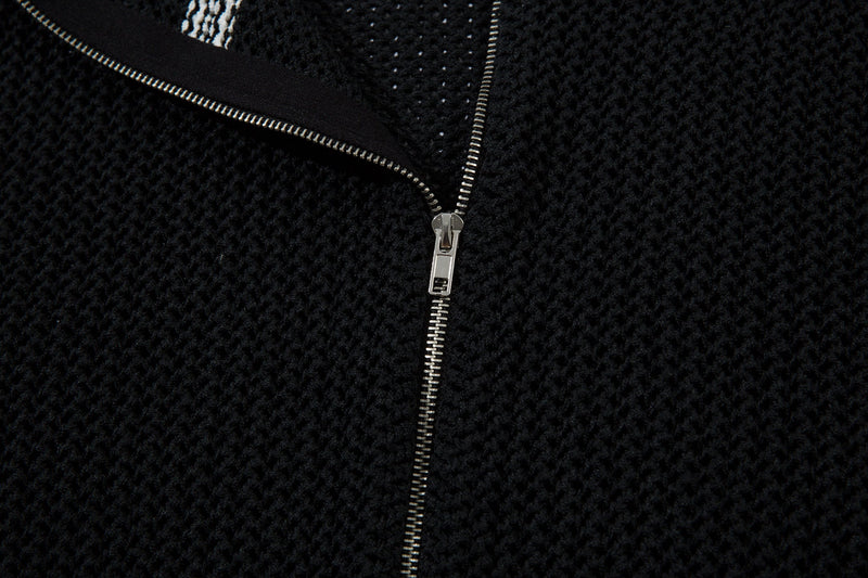 Black zipper and embroidered script logo on mesh knit jacket close-up