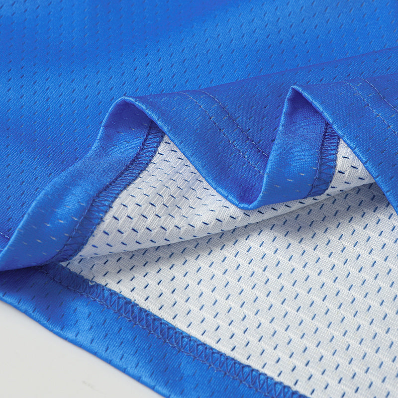 Close-up of a blue football jersey hem with mesh lining and stitched trim, styled for Tom and Jerry varsity streetwear