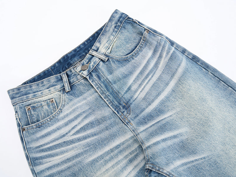 Close-up of front waist and pocket details on washed blue jeans