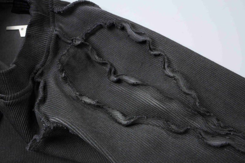 Black ribbed deconstructed compression tee with raw frayed seams and distressed cutout detailing