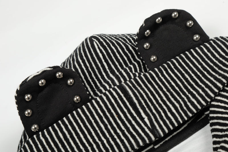 Close-up of black striped hood with black studded bear ears