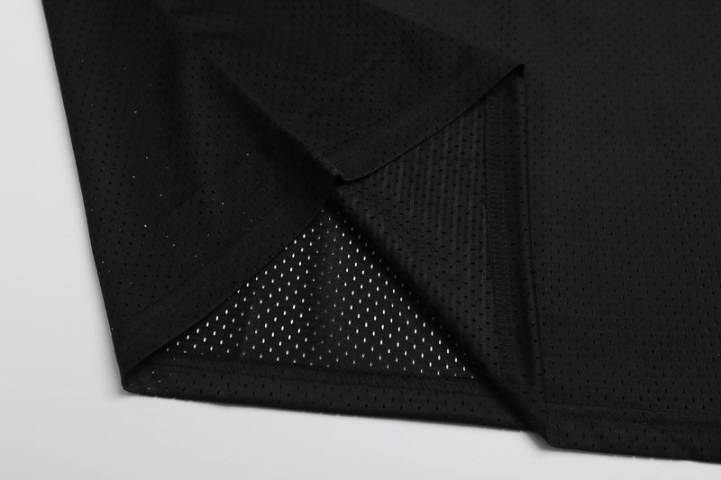 Black mesh football jersey fabric with layered panels and breathable perforations, styled for gothic streetwear