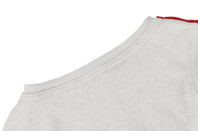 Side close-up of white hoodie shoulder and red double stripe sleeve detail