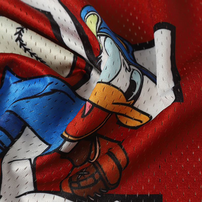 Close-up of Donald Duck graphic on a red and white football jersey with blue accents and mesh fabric texture