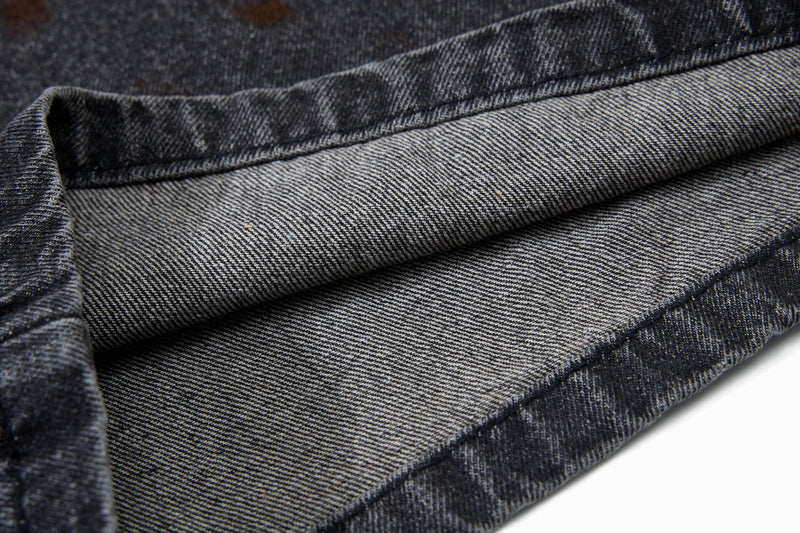 Close-up of folded gray denim fabric showing the inside weave and seam finish