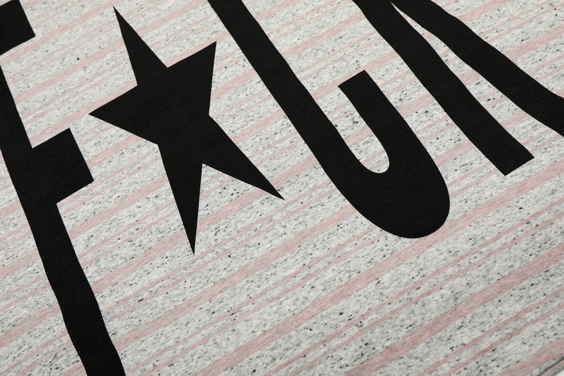 Close-up of black graphic lettering on gray striped fabric