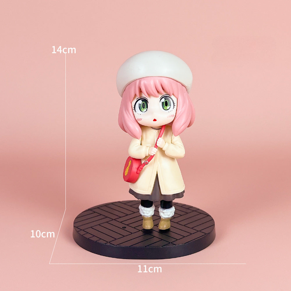 The Spy x Family Detective Anya PVC Figure Set showcases a chibi pink-haired figure in a cream coat and white beret. Standing on a black base with a red bag, it measures 14 cm tall against a soft pink backdrop.