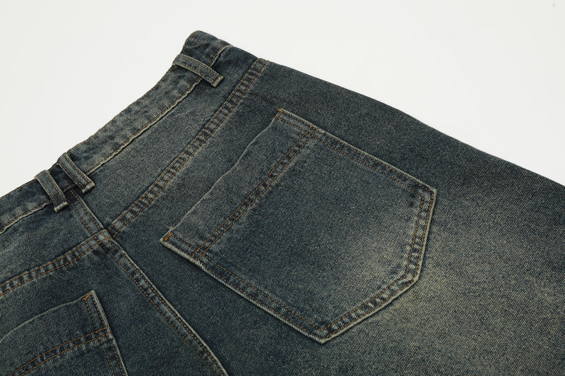 Close-up of the back pocket on dark wash denim shorts with faded denim paneling