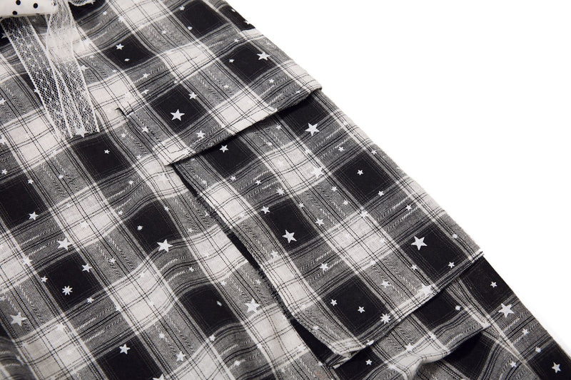 Side cargo pocket on black and white plaid shorts with star print