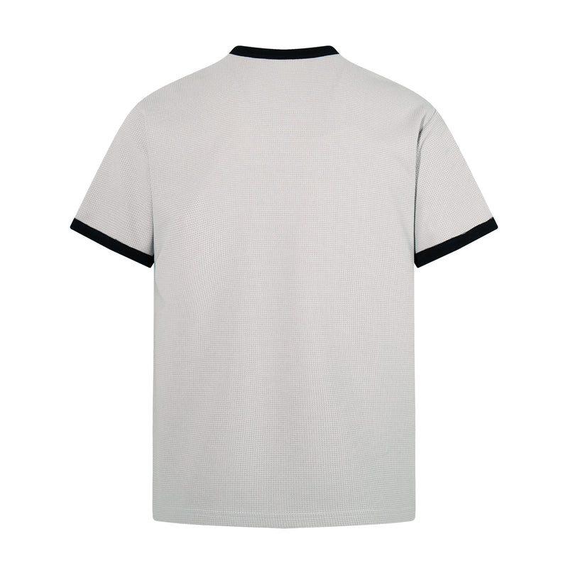 White textured short sleeve T-shirt with black ribbed collar and sleeve trim, shown from the back on a plain background