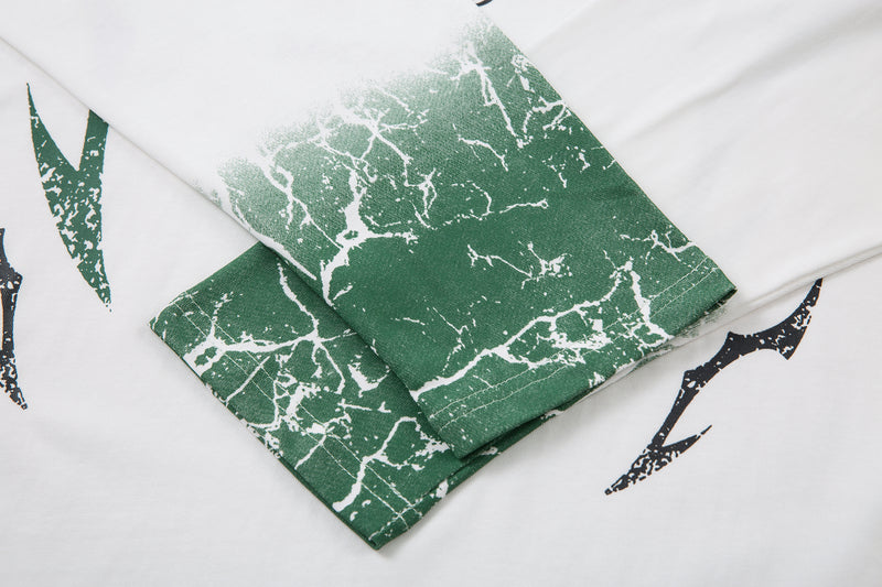 Overlapping white tee sleeves with green cracked cuff print