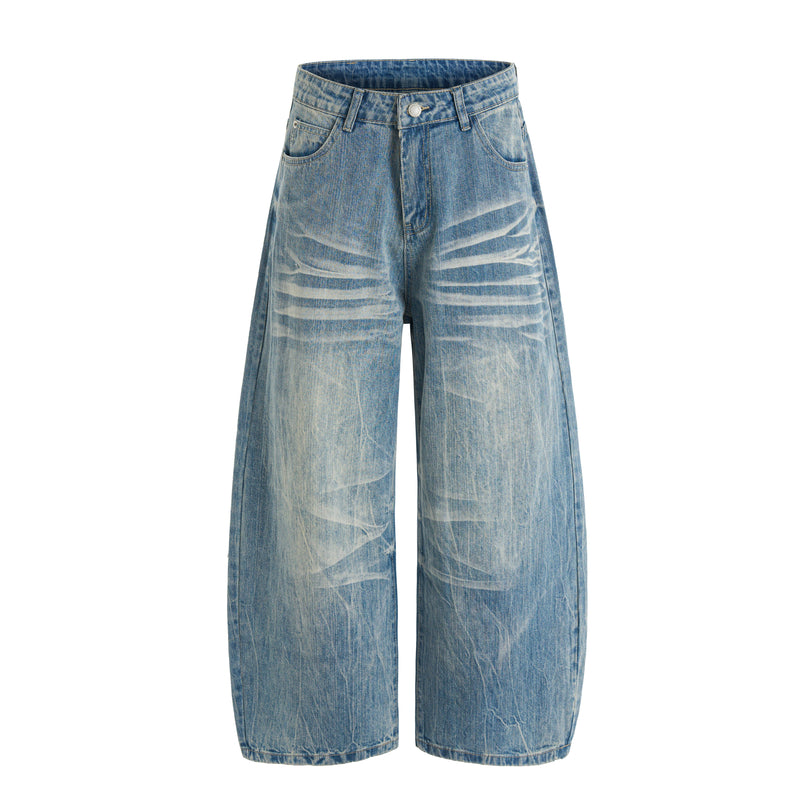 Front view of heavy washed wide-leg blue denim jeans with faded streaks and a button fly