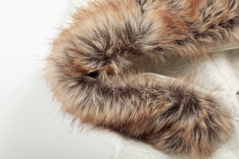 Close-up of white faux-fur hood trim with brown and gray fibers