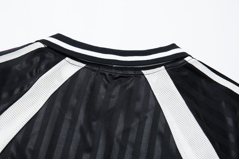 Close-up of black jersey collar with white trim and white shoulder panels