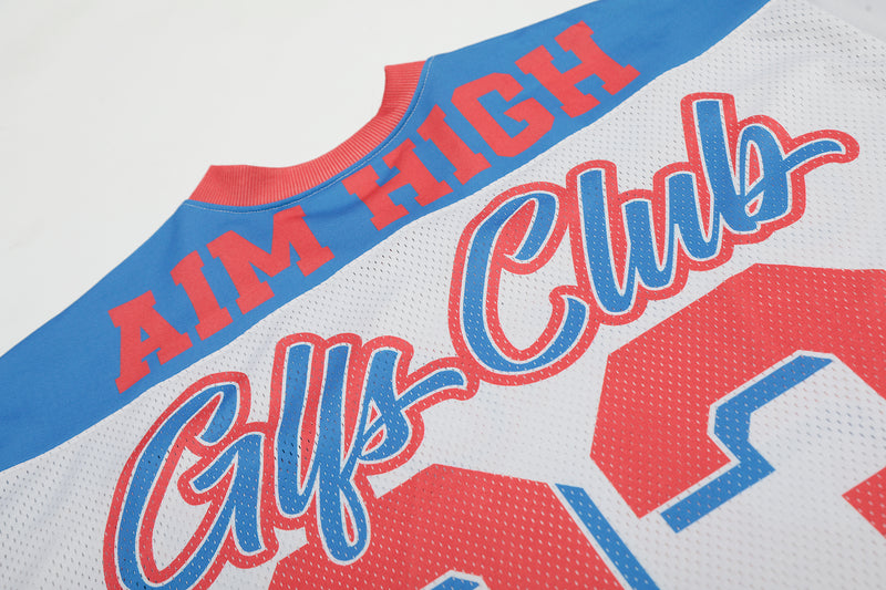 Close-up of a retro colorblock football jersey with blue, white, and red panels, AIM HIGH text, and Glfs Club lettering