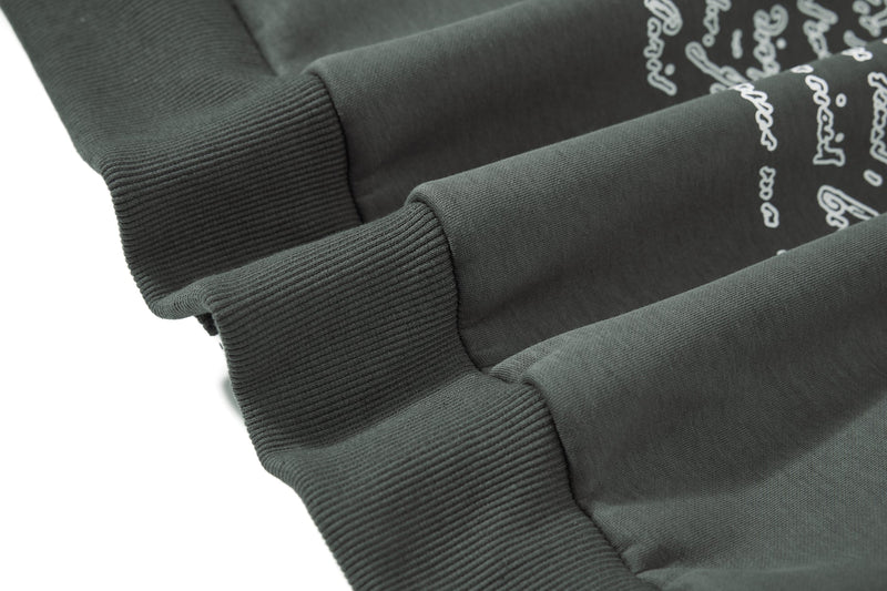 Close-up of ribbed sleeve cuffs on dark green hoodie