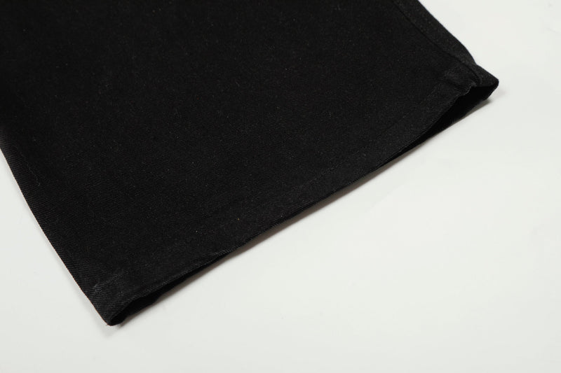 Close-up of black pant leg hem with straight stitched finish