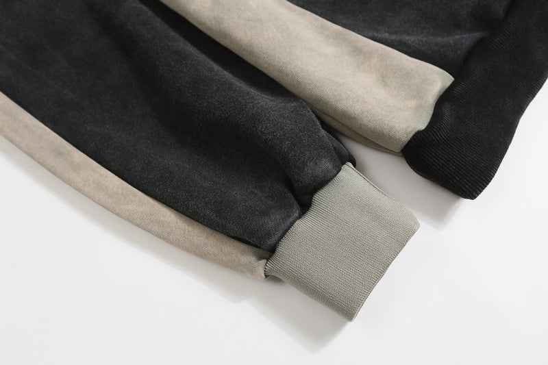 Folded black and gray sweatshirt sleeves with ribbed cuffs and contrast side panels