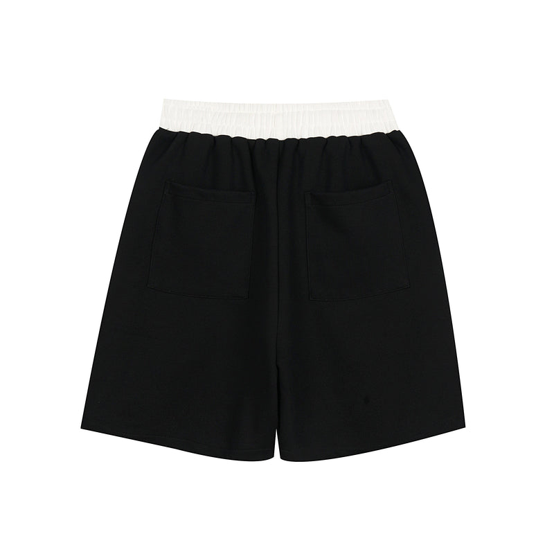 Back view of black sport shorts with white waistband and two patch pockets
