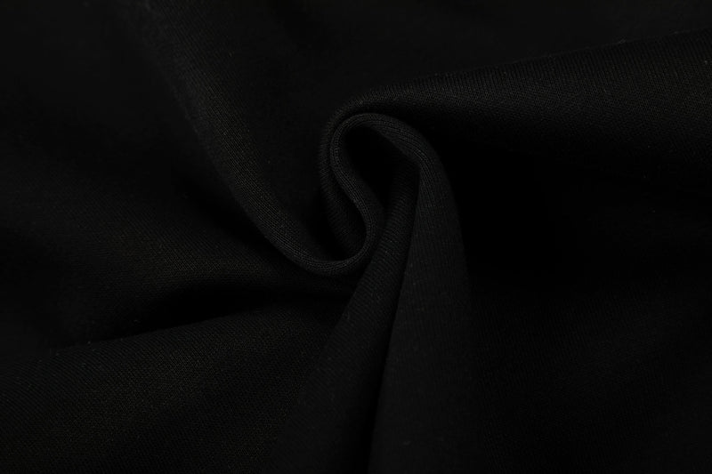 Close-up of black hoodie fabric fold on a plain white background