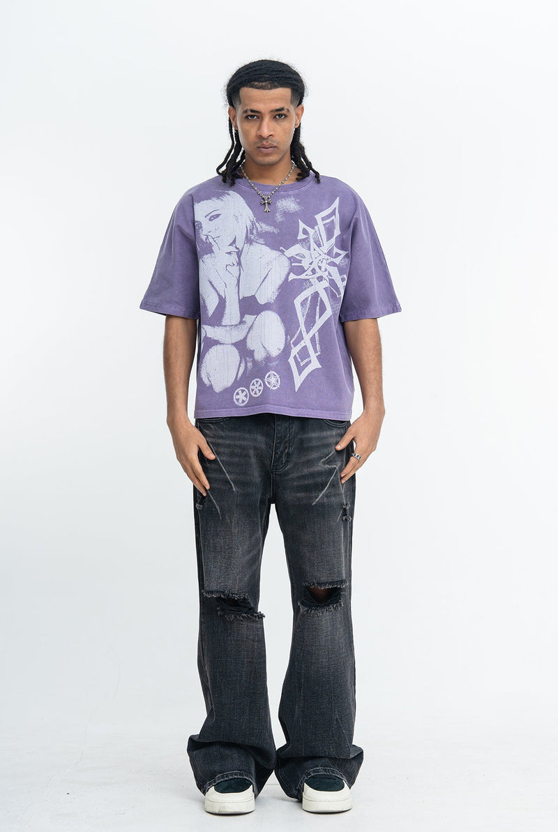 Purple vintage washed graphic T-shirt with gothic print, worn with black ripped jeans and white sneakers on a model