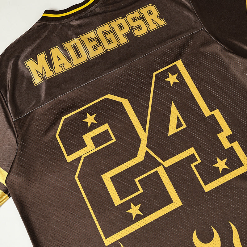 Brown and gold varsity jersey with large 94 graphic, Madesr lettering, and flame details on the back