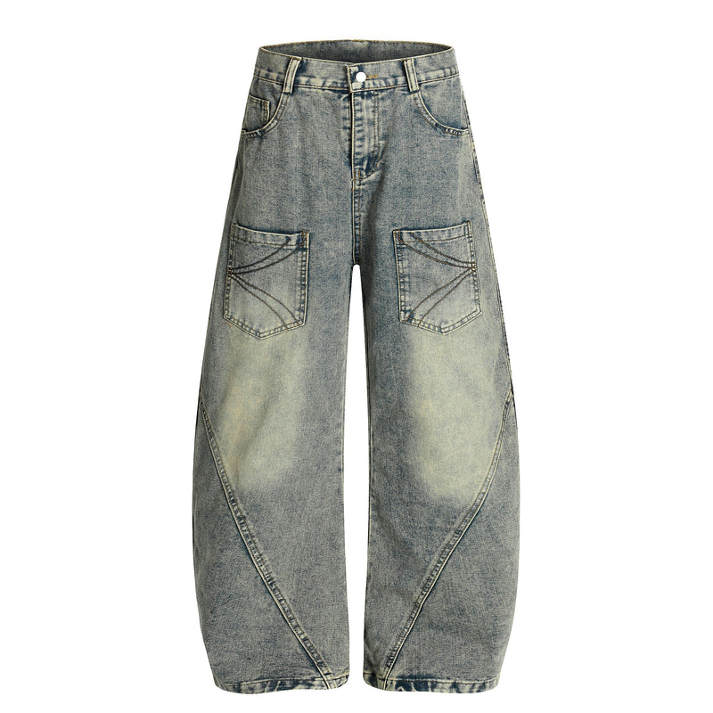 Light wash wide-leg denim jeans front view with large stitched patch pockets and arc seams