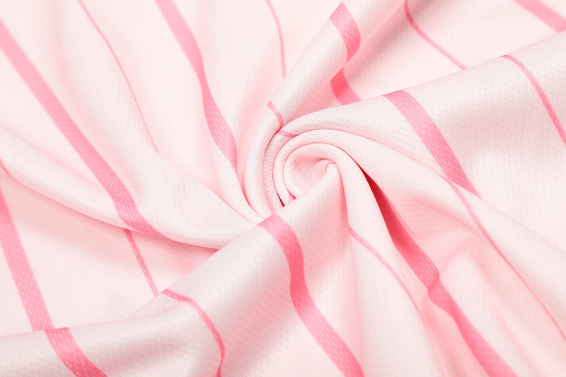 Close-up of pink pinstripe jersey fabric folded into a swirl