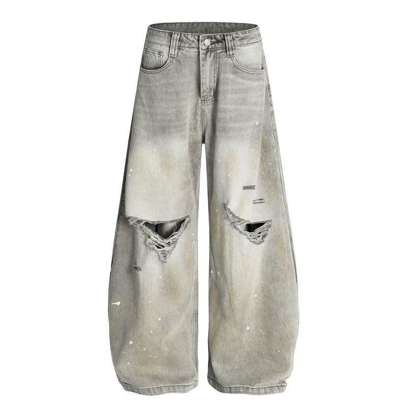Front view of light gray wide-leg jeans with distressed knees and white paint splatter